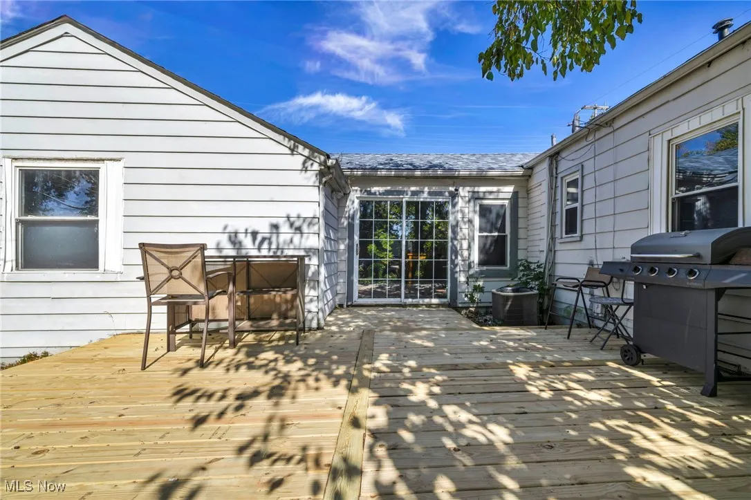 Wooden terrace featuring grilling area