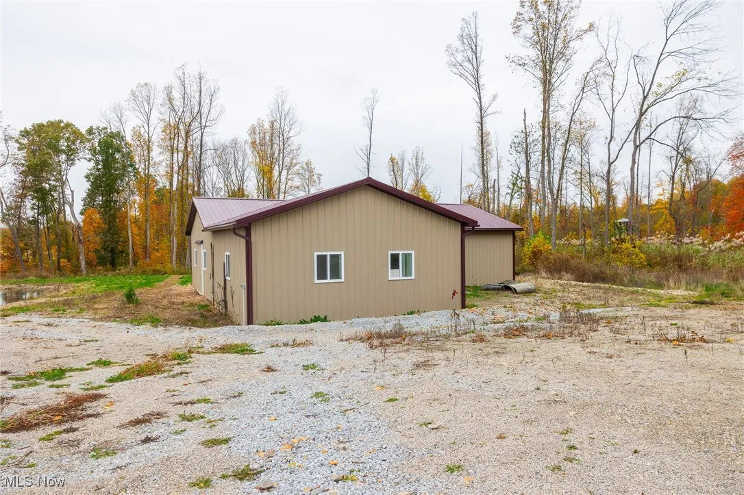 View of side of property featuring a metal roof