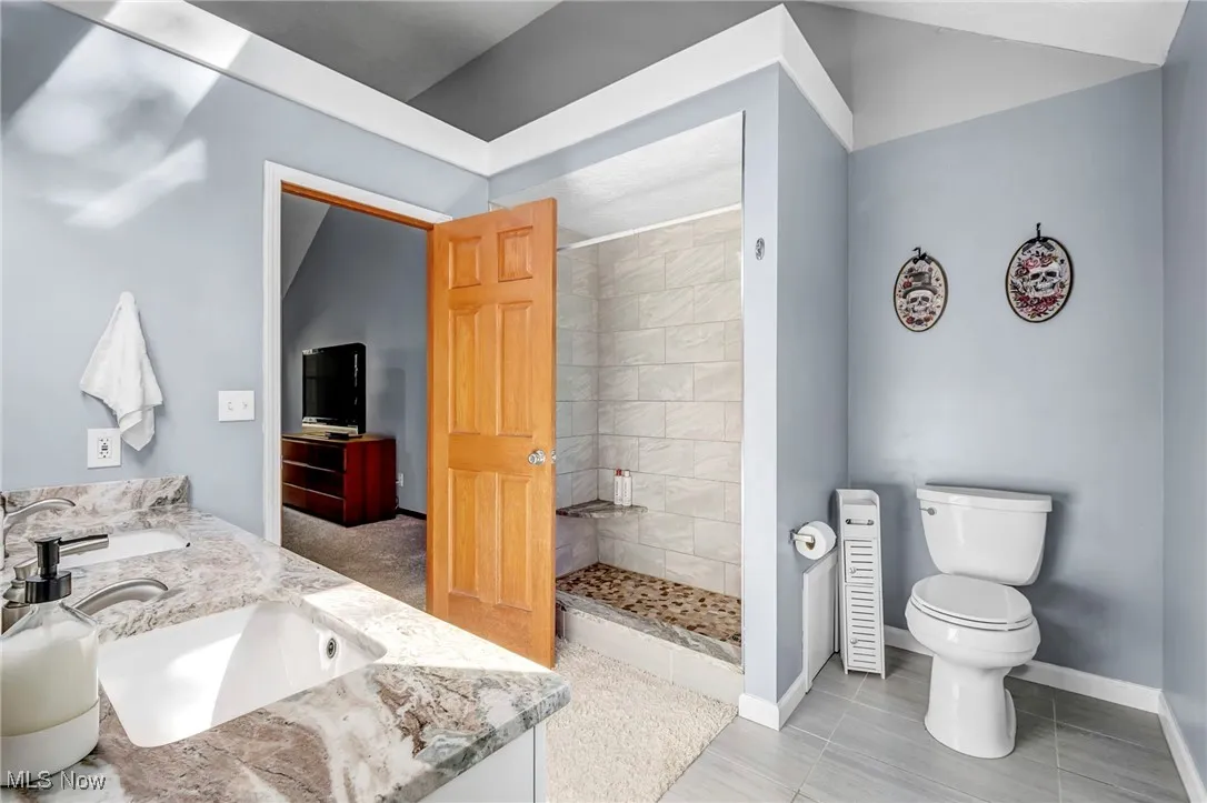 Full bathroom with a shower and double vanity