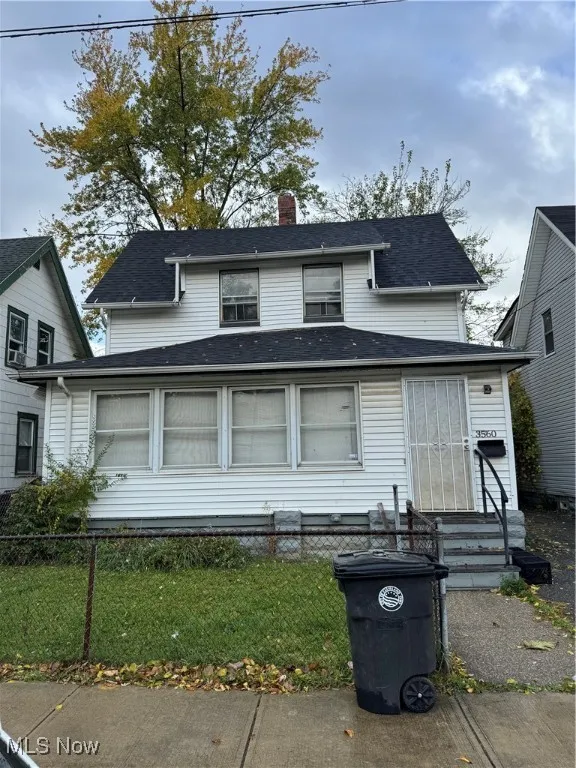 View of front of house featuring a chimney, a fenced front yard, roof with shingles, and entry steps