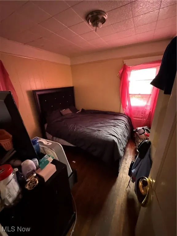 Bedroom featuring dark wood-style floors
