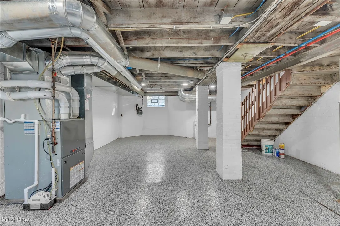 Below grade area with heating unit and gas meter