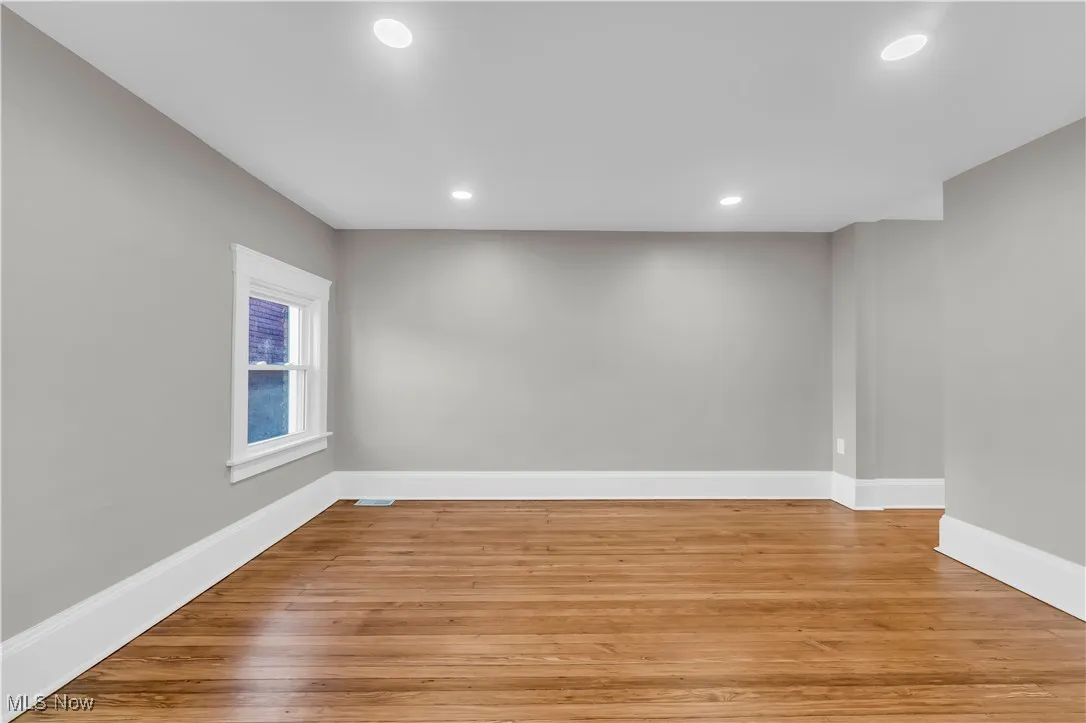 Empty room featuring light wood finished floors and recessed lighting