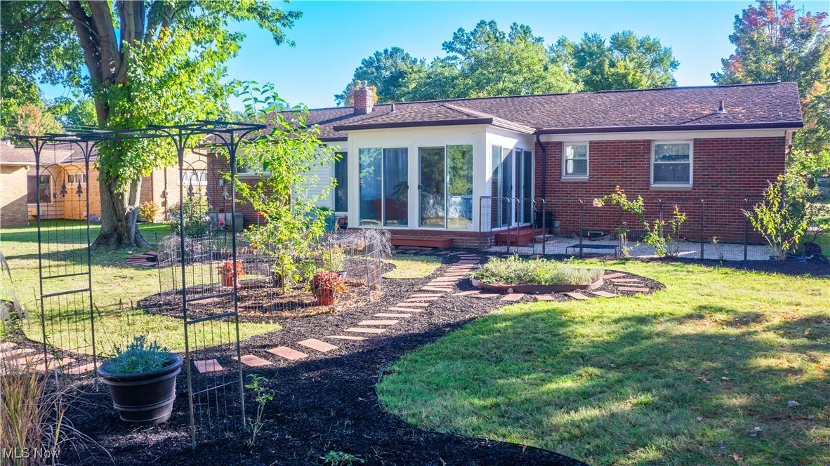 A rear view of this very special home with its neatly arranged back garden