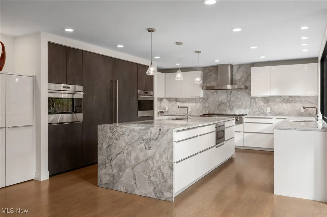 A perfect balance of Leicht cabinetry and an oversized center island add style to the kitchen while three Asko dishwashers, separate Sub Zero fridge and freezer, Wolfe ovens and six burner cooktop are the kitchen's hard working essentials.
