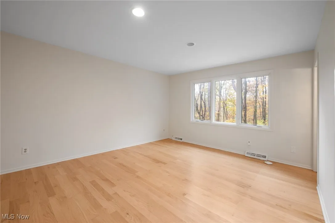 On the second floor, three well-sized bedrooms and one bonus space share....