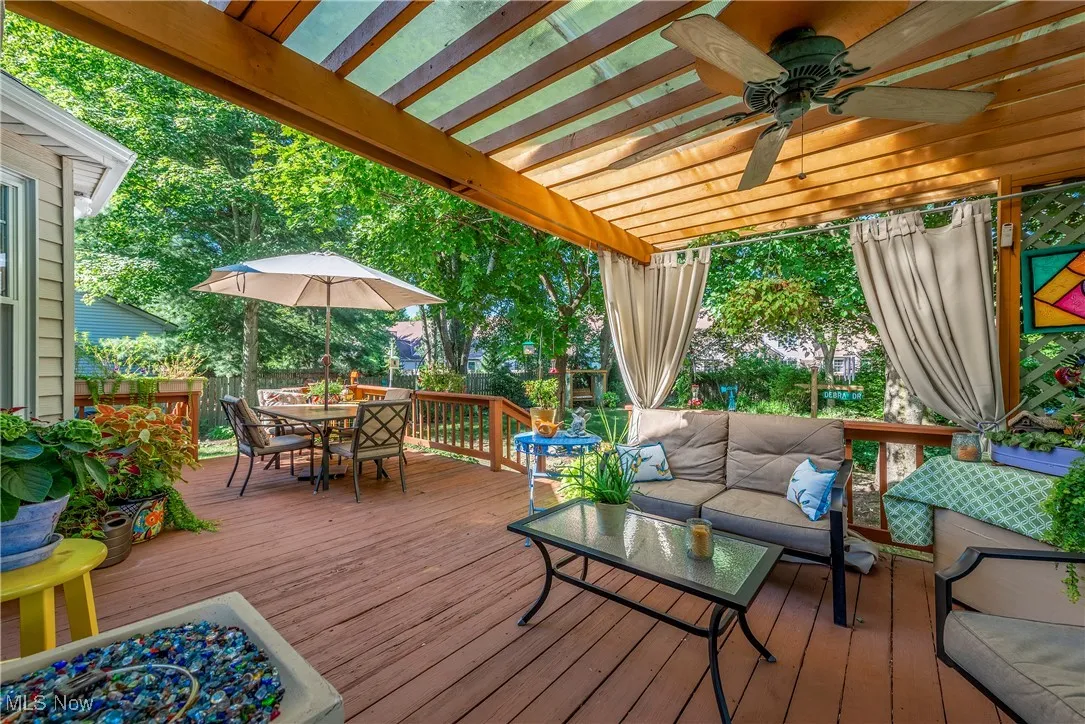 Wooden deck featuring outdoor lounge area, a ceiling fan, and outdoor dining area