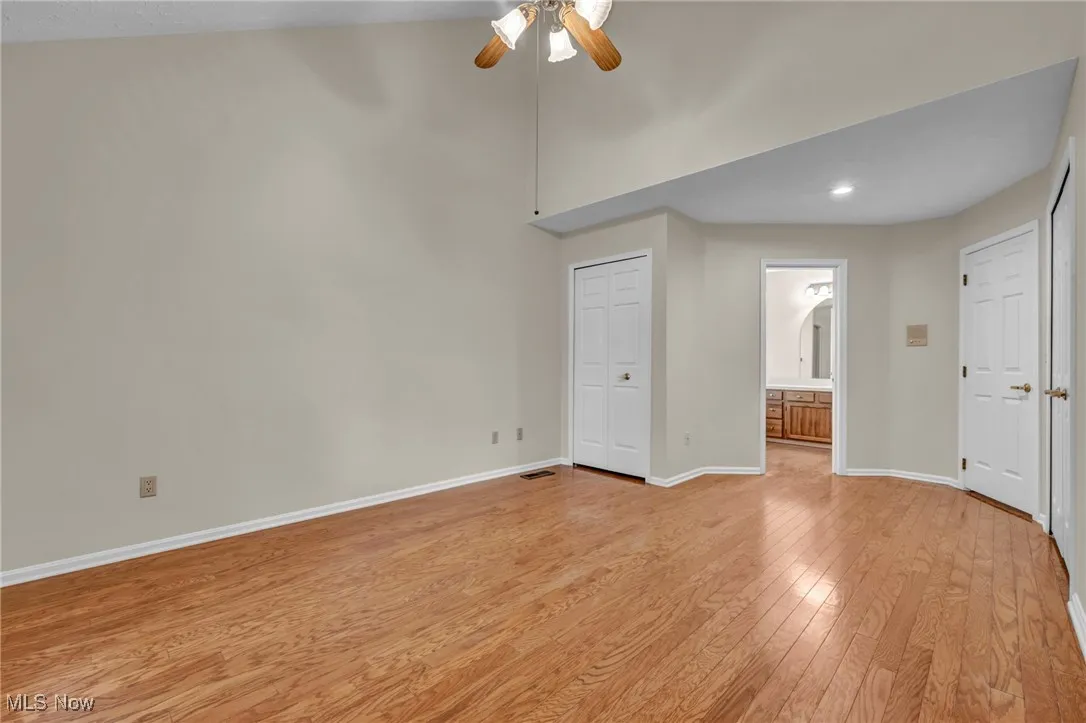 Unfurnished bedroom featuring light wood-style floors, a closet, high vaulted ceiling, ceiling fan, and recessed lighting