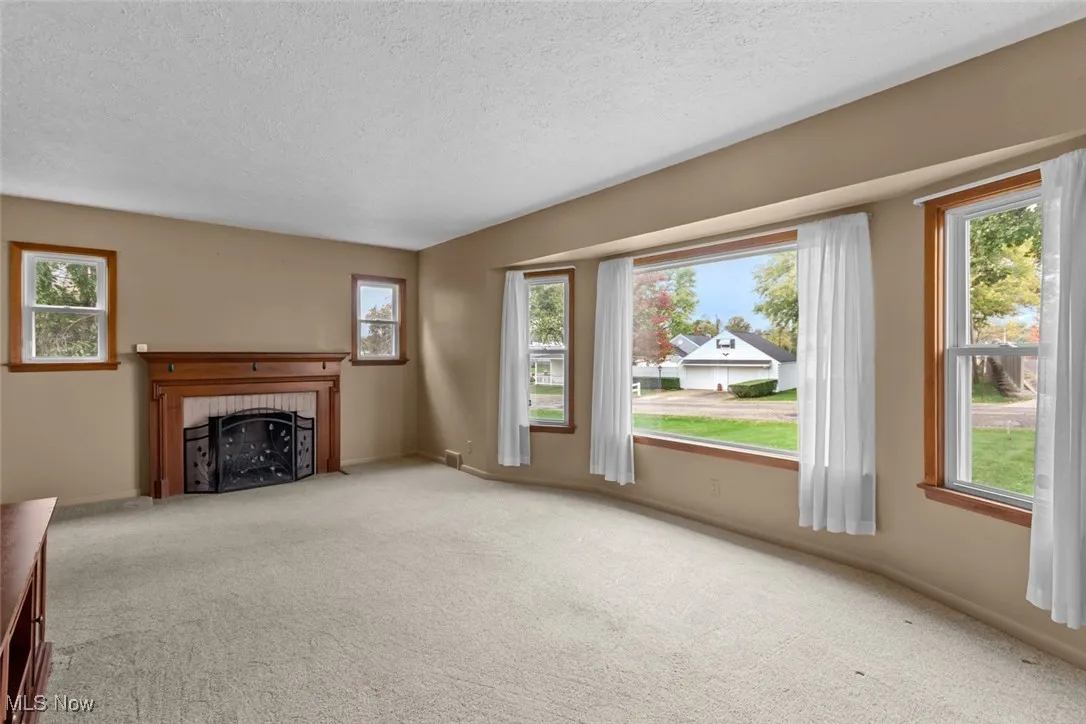 Unfurnished living room - tons of natural light and beautiful fireplace