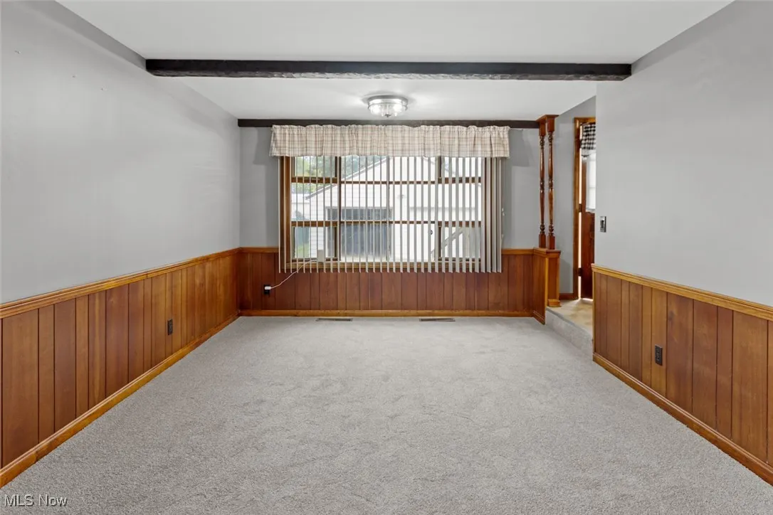 Unfurnished family room with convenient location from foyer or kitchen. Perfect for entertaining!