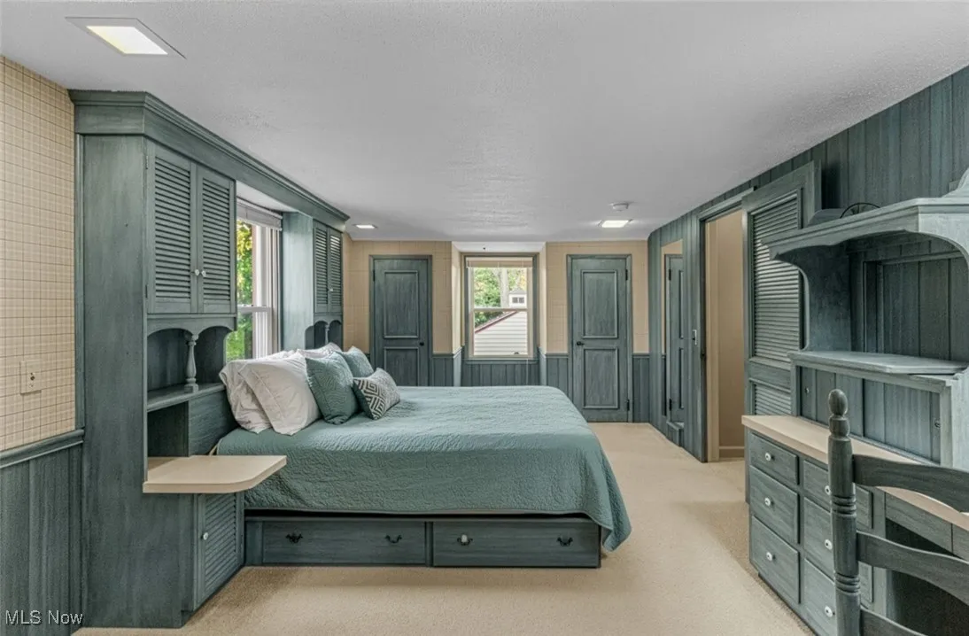 1st bedroom at top of stairs features tons of built ins, double closets and skylight!