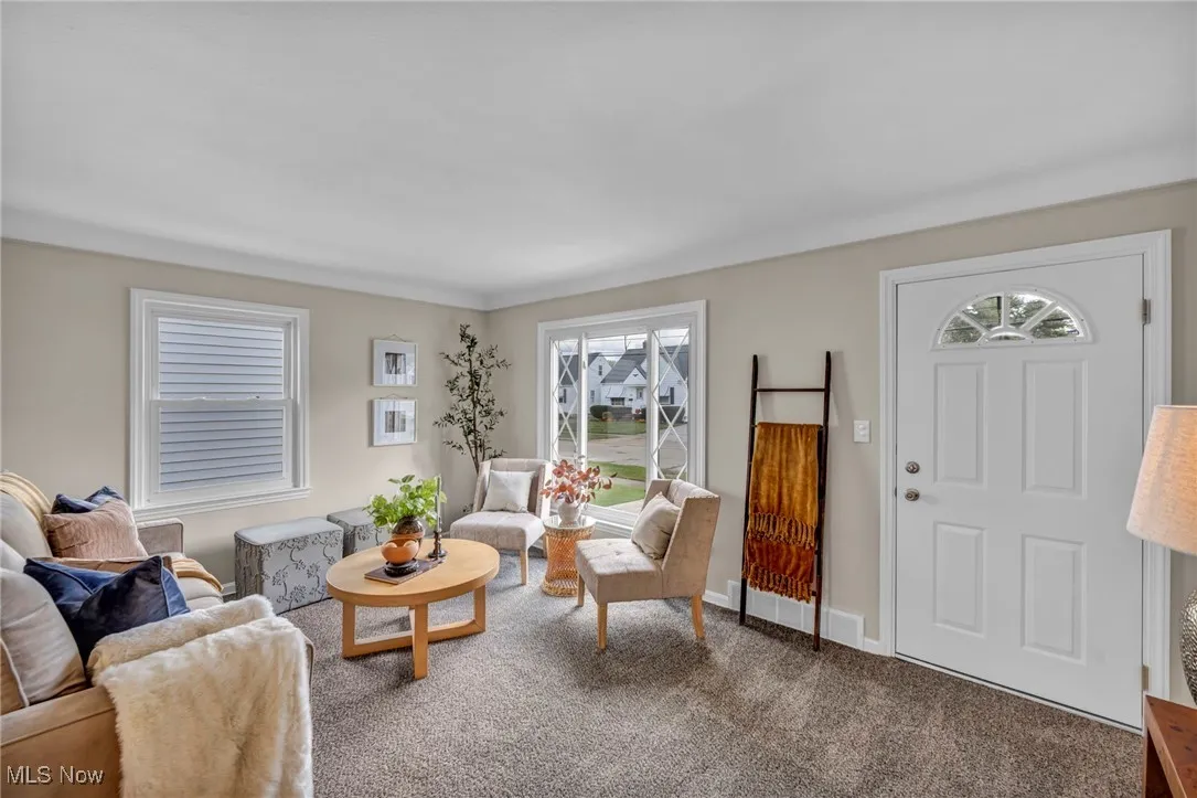 Carpeted living room featuring baseboards
