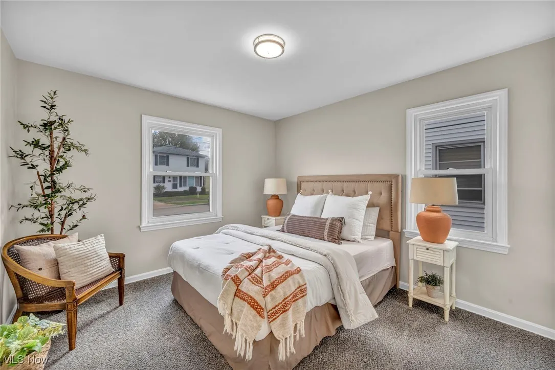 Carpeted bedroom featuring baseboards