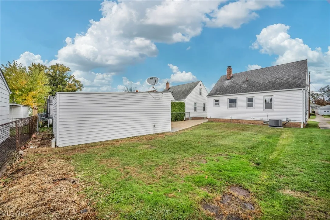 Rear view of property with a patio and a shingled roof