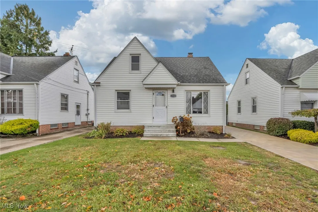View of front facade with a front lawn and a chimney