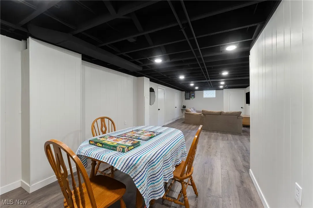 Dining space featuring wood finished floors and wooden walls