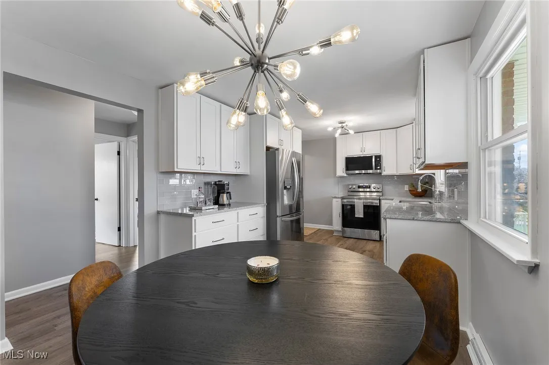 Dining space with vinyl floors and a chandelier