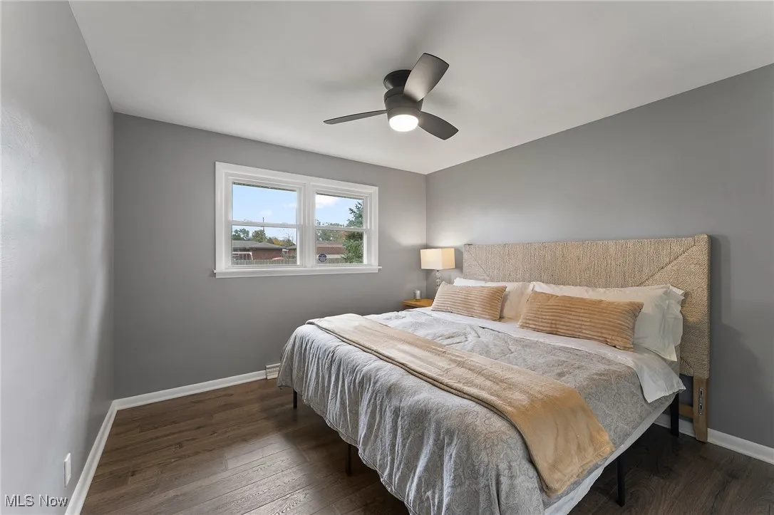 Primary bedroom with vinyl flooring and a ceiling fan