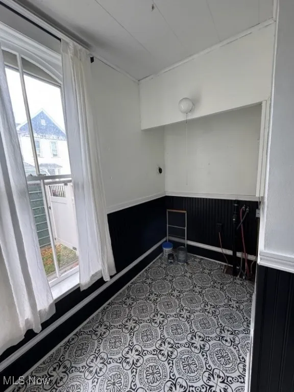 Empty room with a wainscoted wall and wood walls