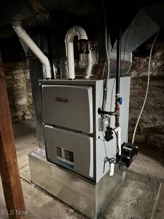 Utility room featuring heating unit