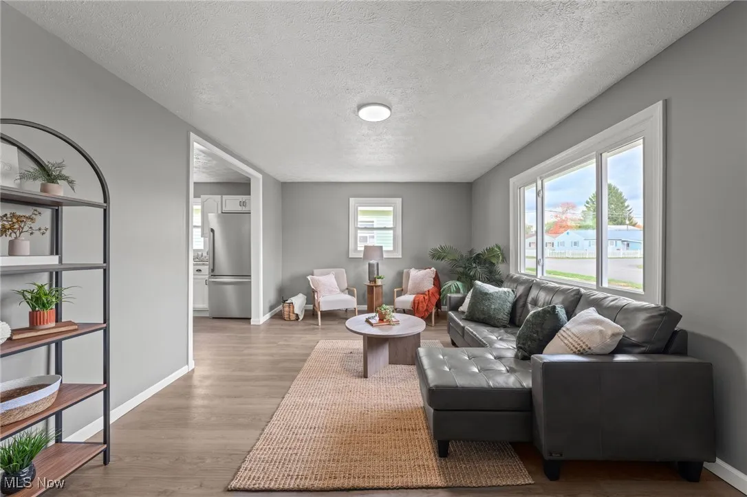 Living area with a textured ceiling and wood finished floors