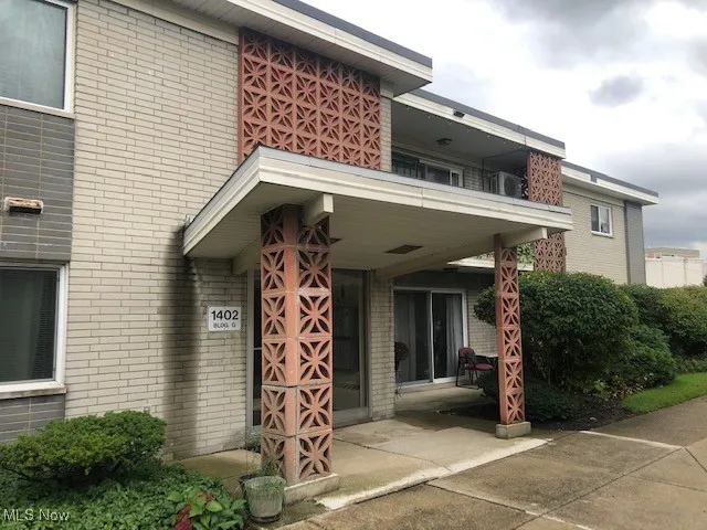 Entrance to property featuring brick siding