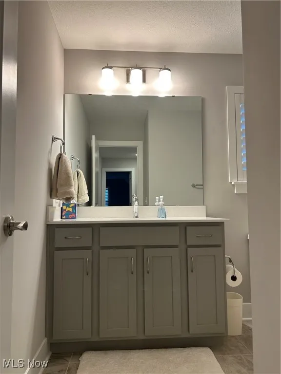 Bathroom featuring vanity and a textured ceiling