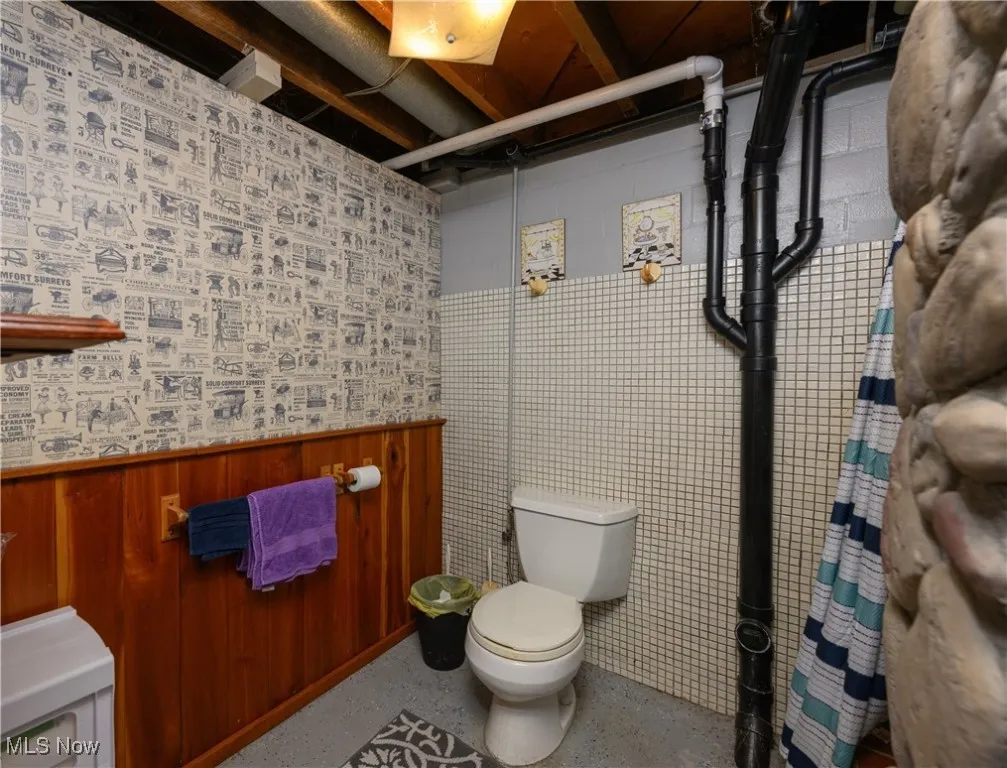 Bathroom with a shower and wainscoting