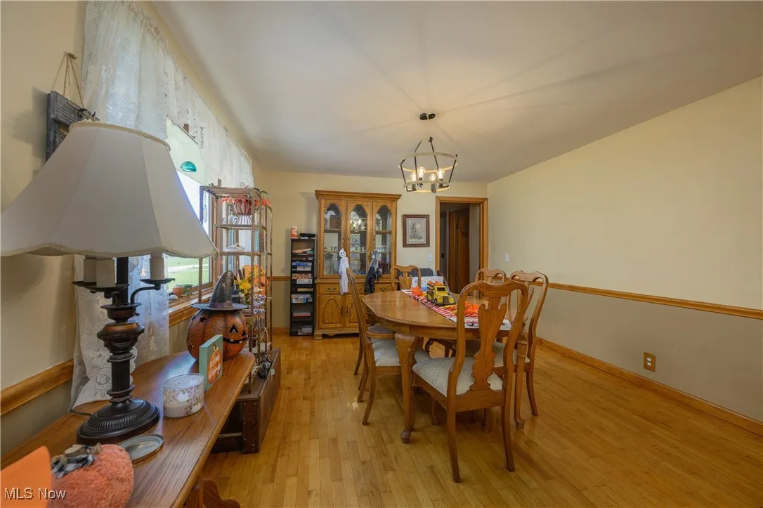 Dining space featuring light wood finished floors and a chandelier