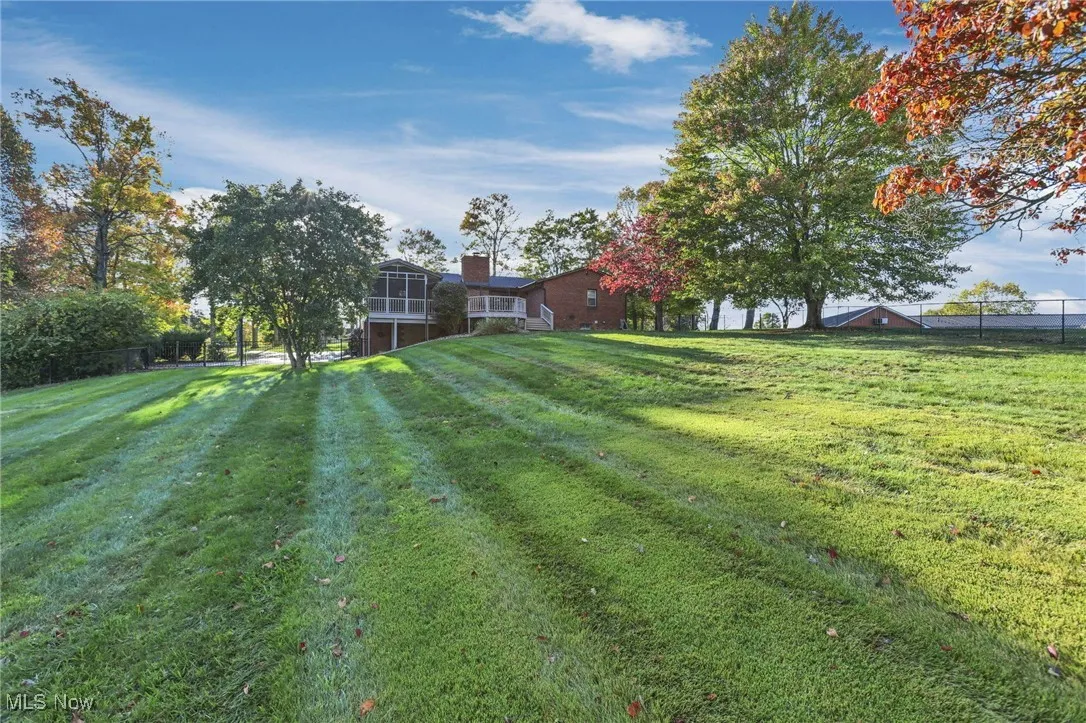 View of yard with a sunroom