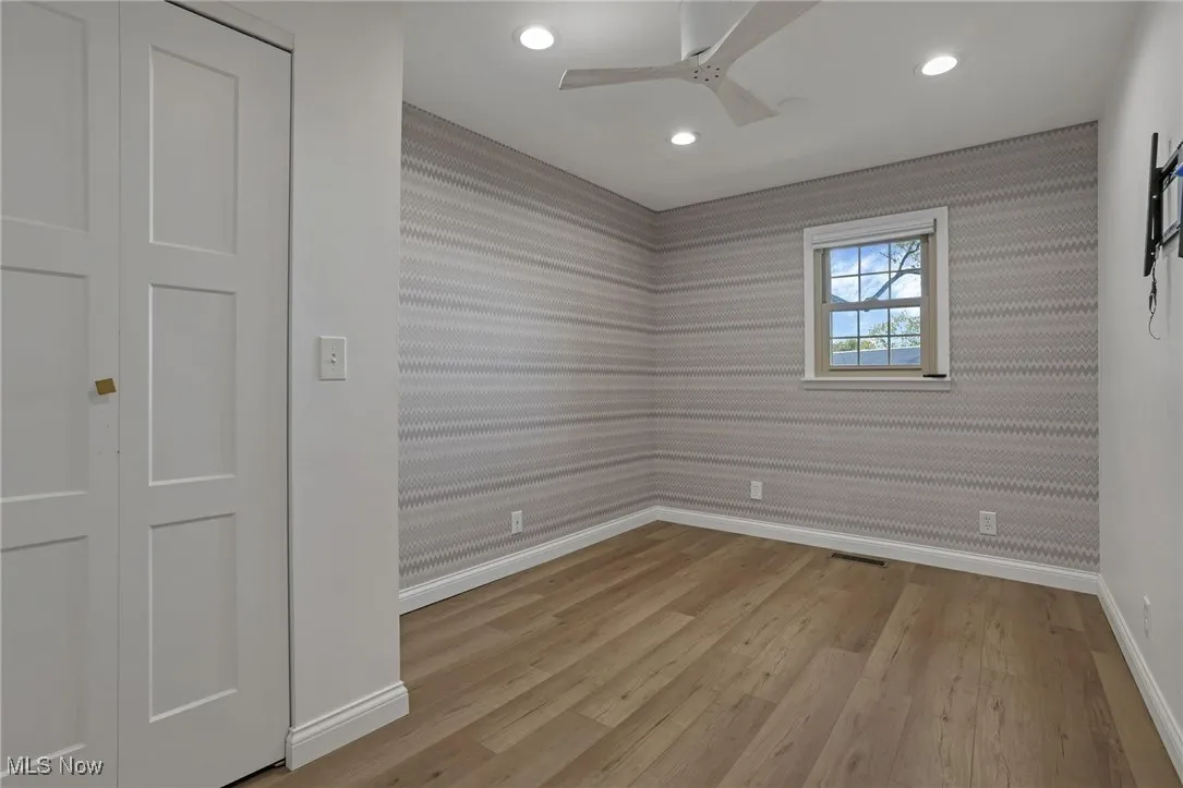 Spare room featuring light wood finished floors, recessed lighting, ceiling fan, and wallpapered walls