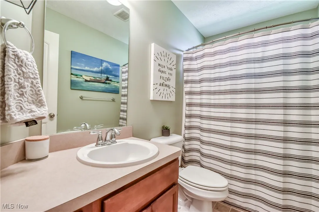 Full bathroom with a shower with curtain and vanity