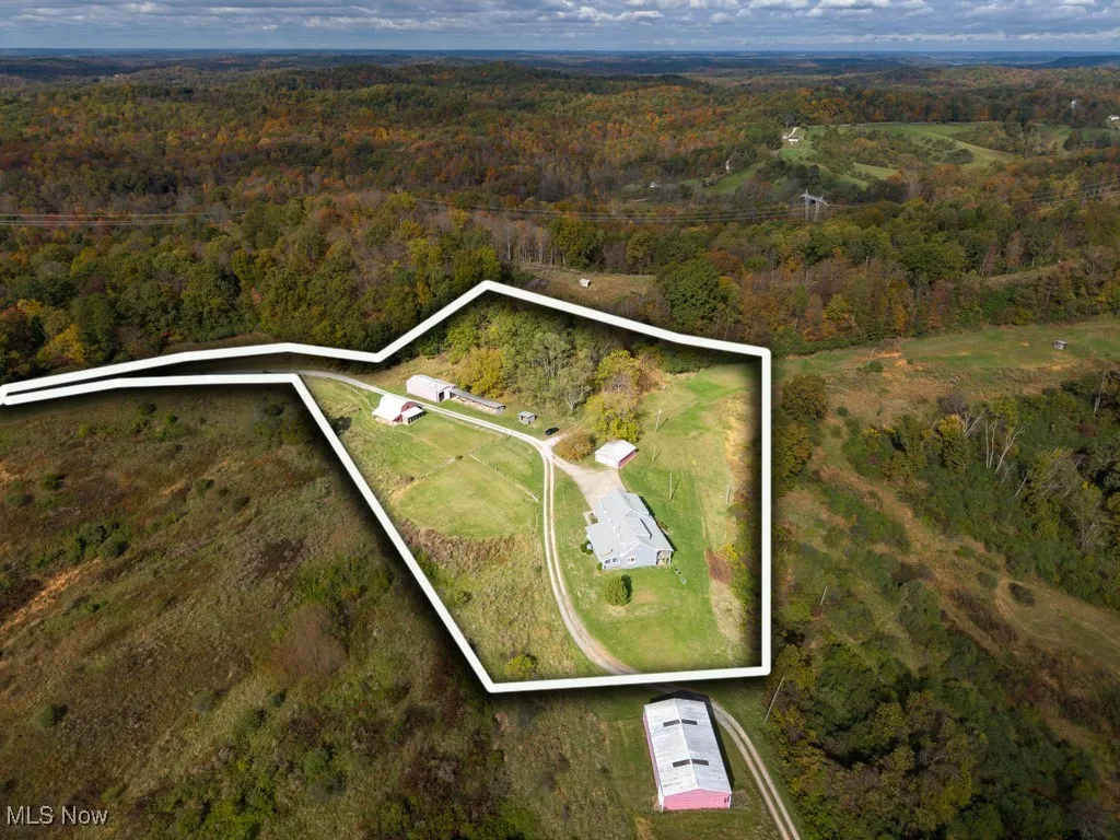 Aerial overview of property's location featuring a forest and property boundaries highlighted