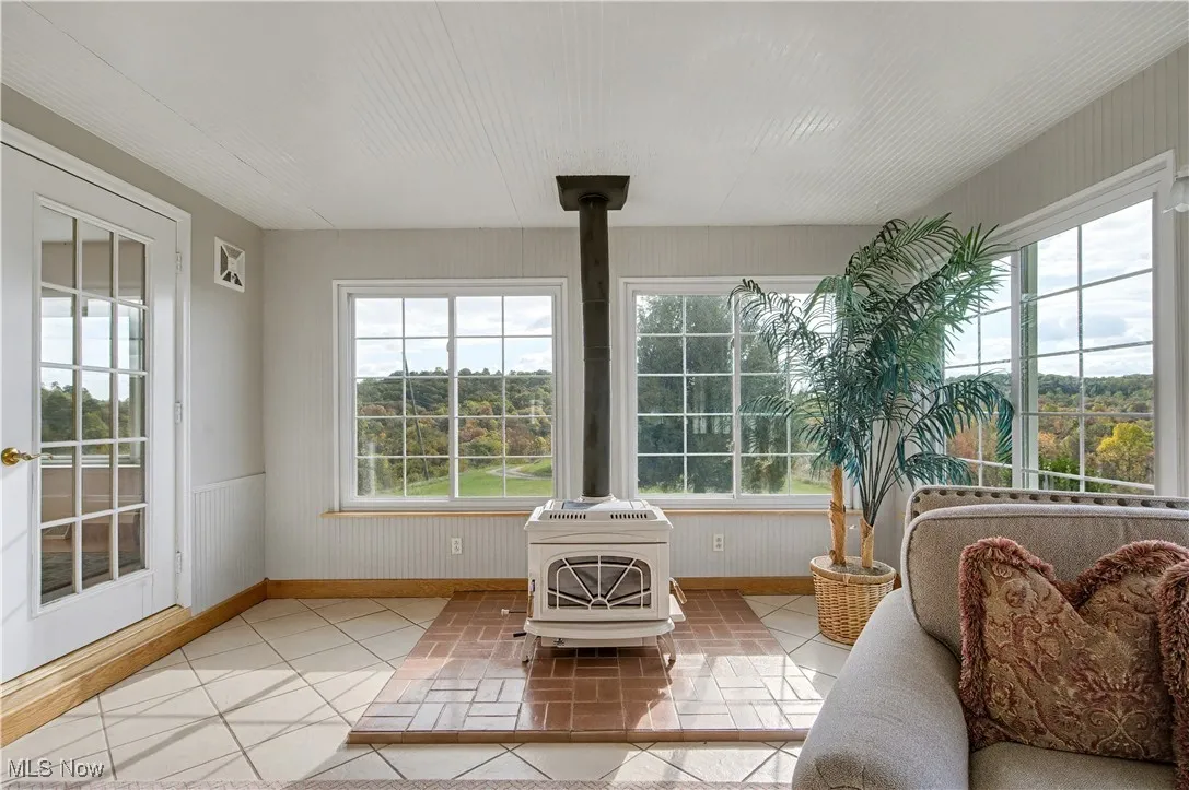 Sunroom featuring a wood stove