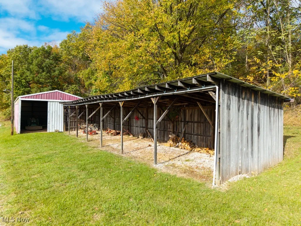 View of pole building with a yard
