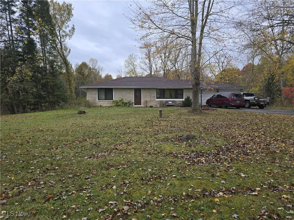 Ranch-style house featuring a front yard and driveway