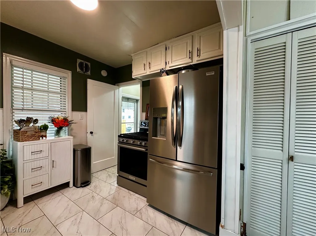 Additional view of kitchen showing exterior door to carport, and pantry doors to the far right, which are just inside the dining room area.