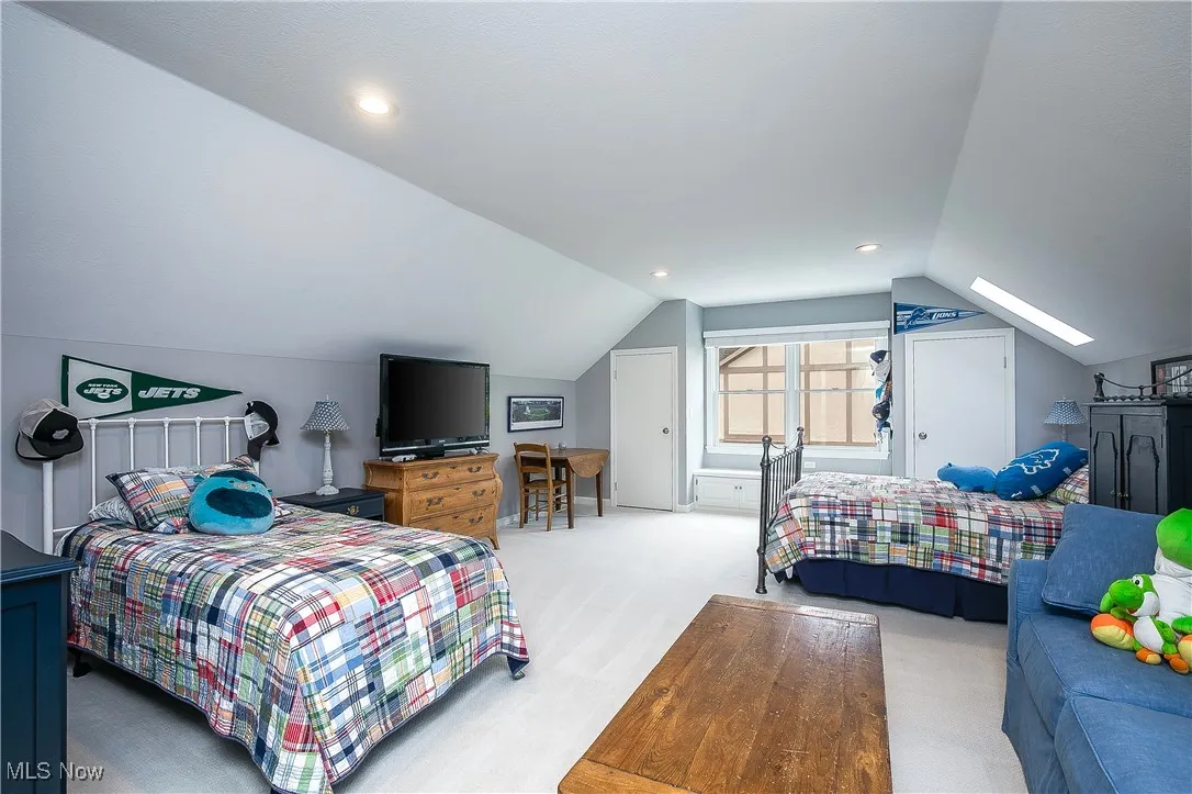 Bedroom featuring carpet floors, lofted ceiling, a skylight, and recessed lighting