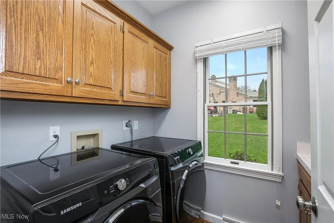 Laundry area with cabinet space and washer and dryer
