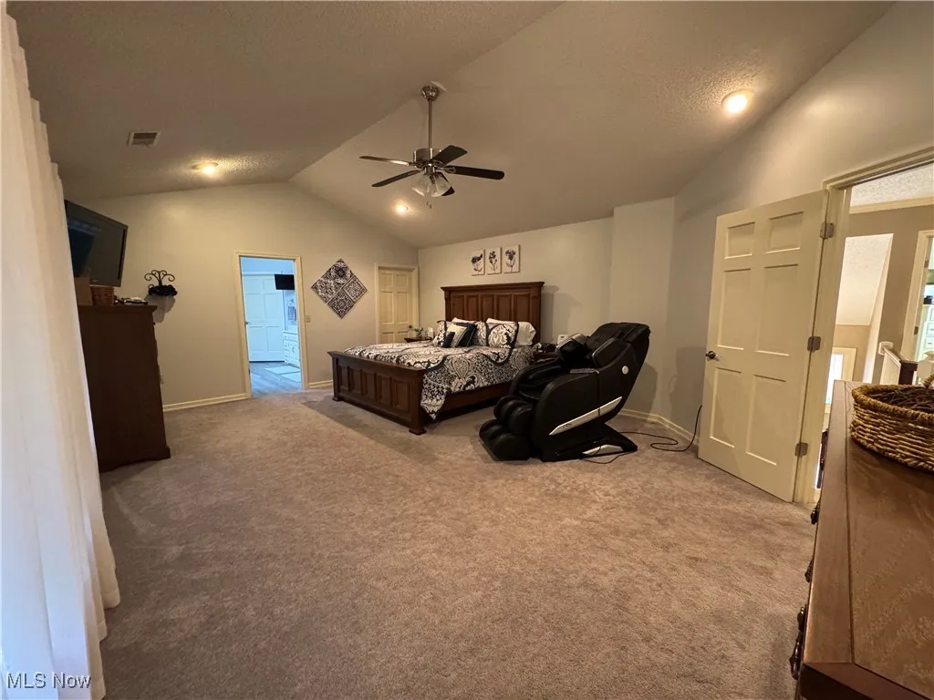 Primary bedroom with vaulted ceilings, large bathroom, walk in closet with built-ins and bonus closets and storage