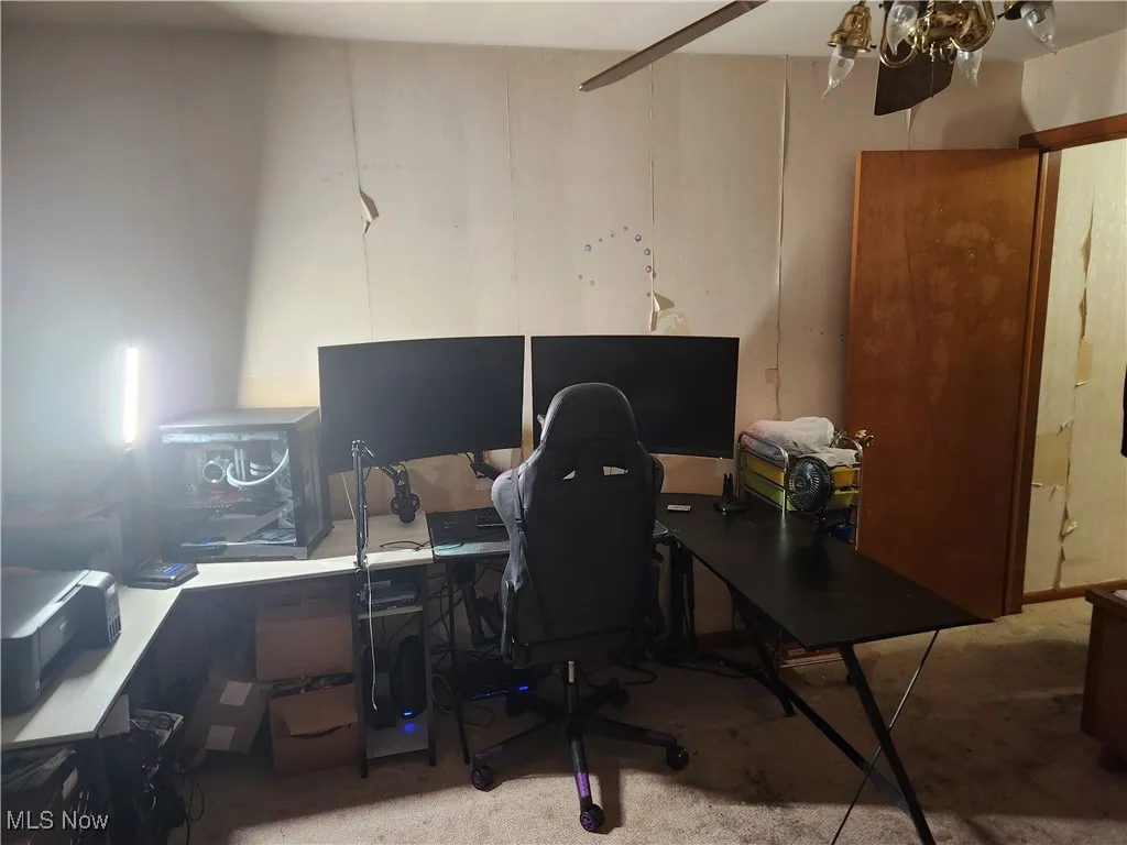 Carpeted office with ceiling fan