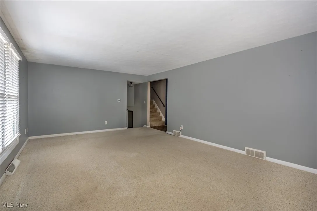 Spare room with carpet and stairs