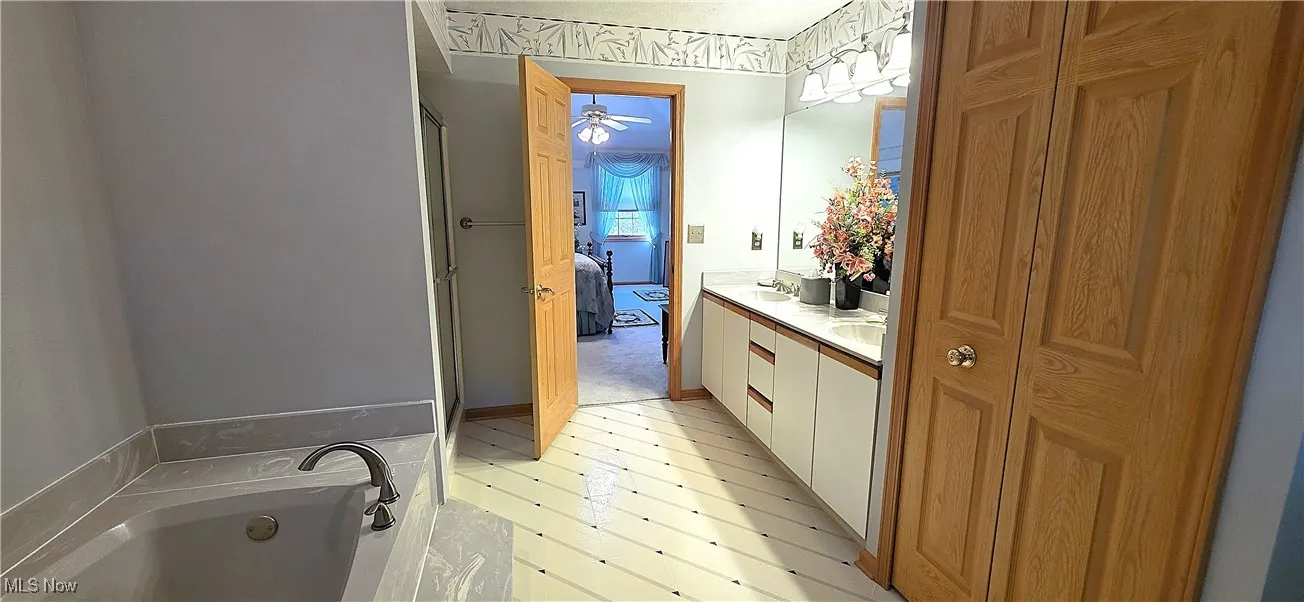 Master Bathroom with Double Bowl Vanity, a soaking bath tub and a shower stall.