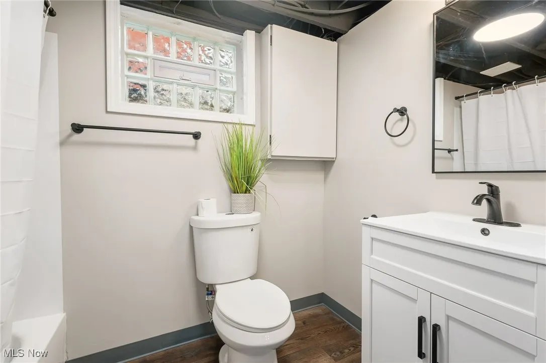 Bathroom featuring vanity and dark wood finished floors