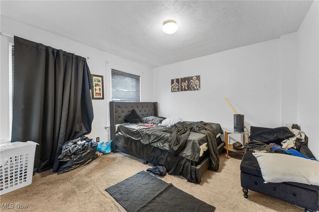 Bedroom with carpet floors and a textured ceiling