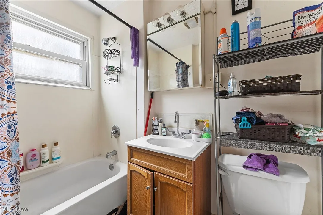 Full bathroom featuring shower / tub combo and vanity