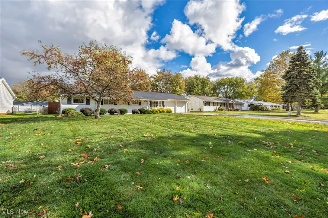 View of front of house with a front yard and an attached garage