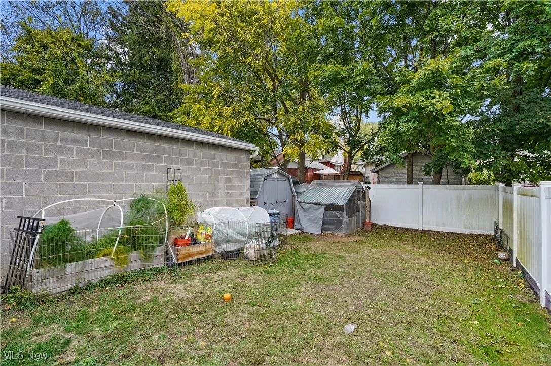 Completely fenced in back yard with garden area and shed.