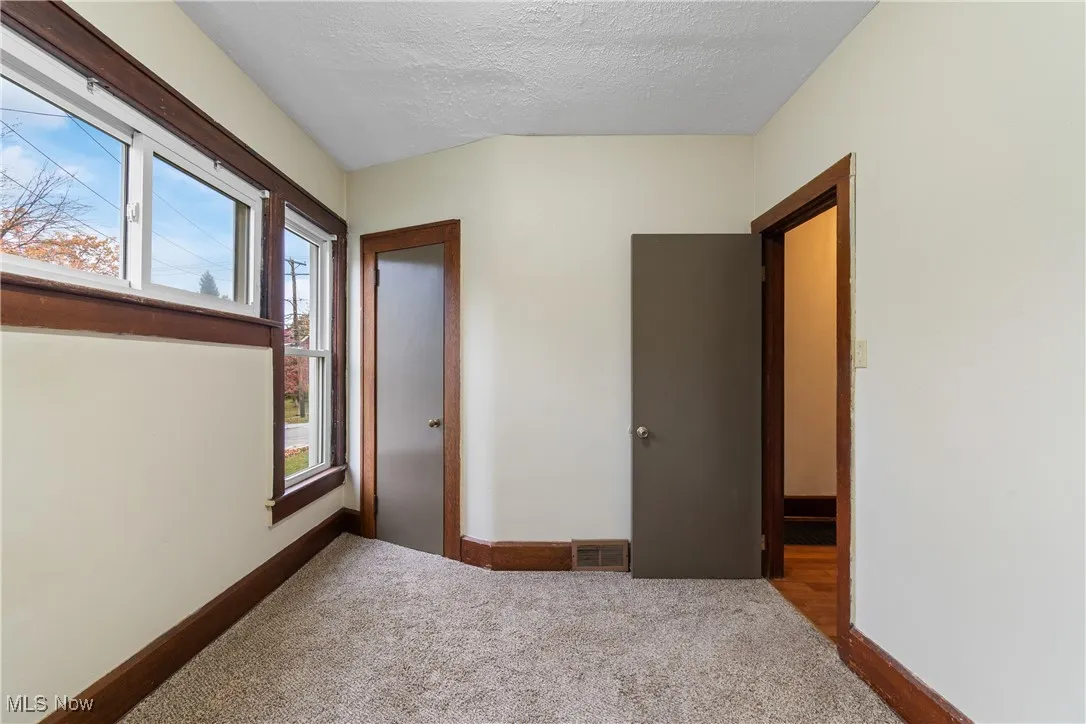 Bedroom with carpet floors and a textured ceiling