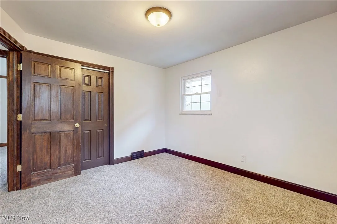 Unfurnished bedroom featuring carpet floors and a closet